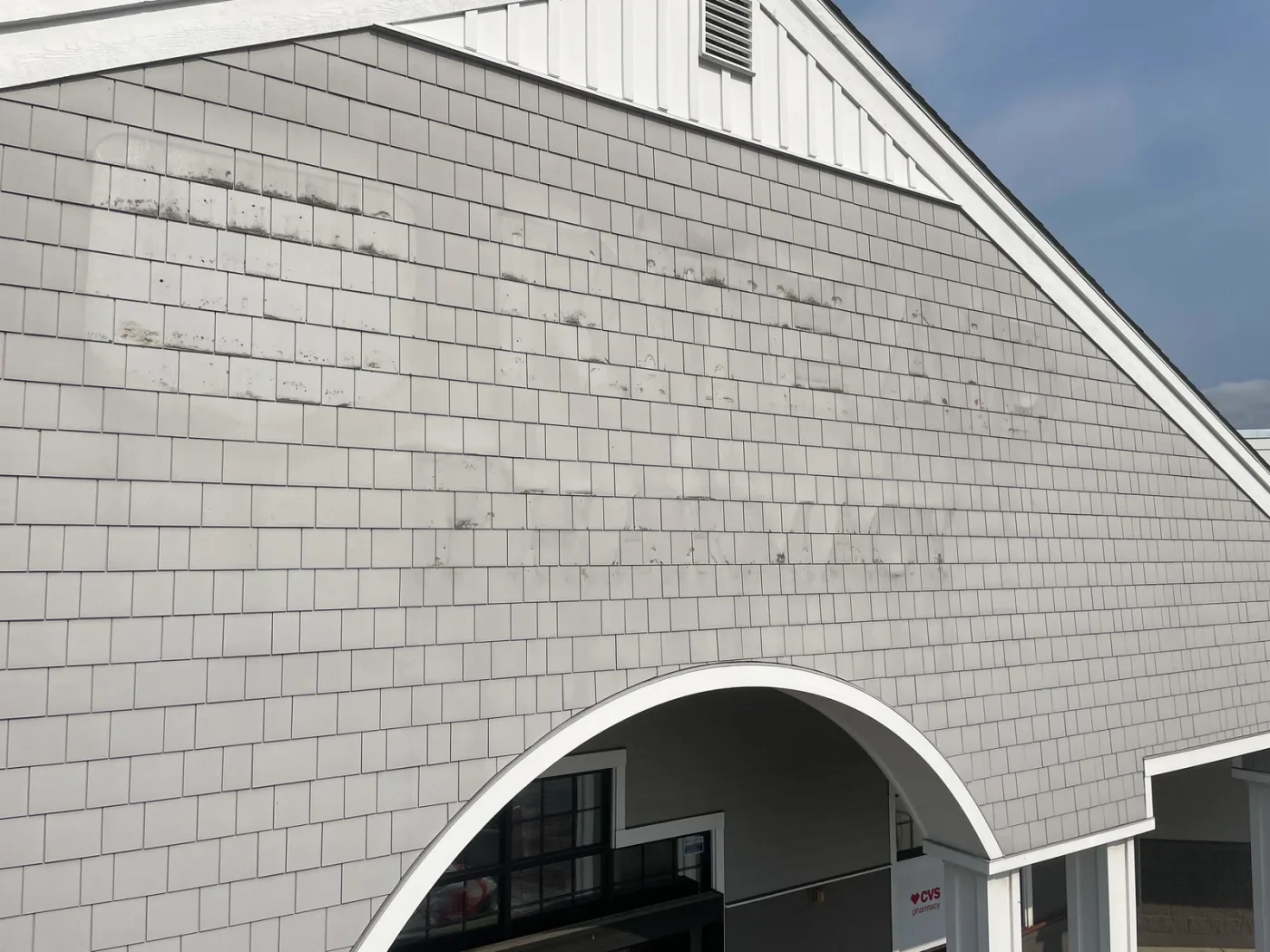 Pharmacy retail gable exterior wall in Freeland, WA showing existing cedar shake surface prior to commercial repaint