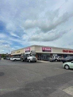 Wireless retail store exterior before commercial repainting in Evansville, IN - existing condition (view 2)