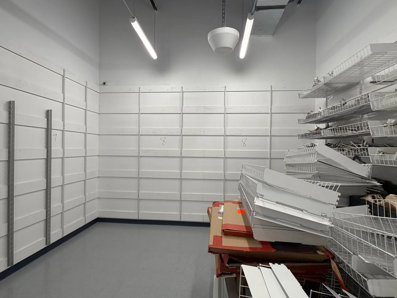 Stockroom racking pulled forward from the wall before painting