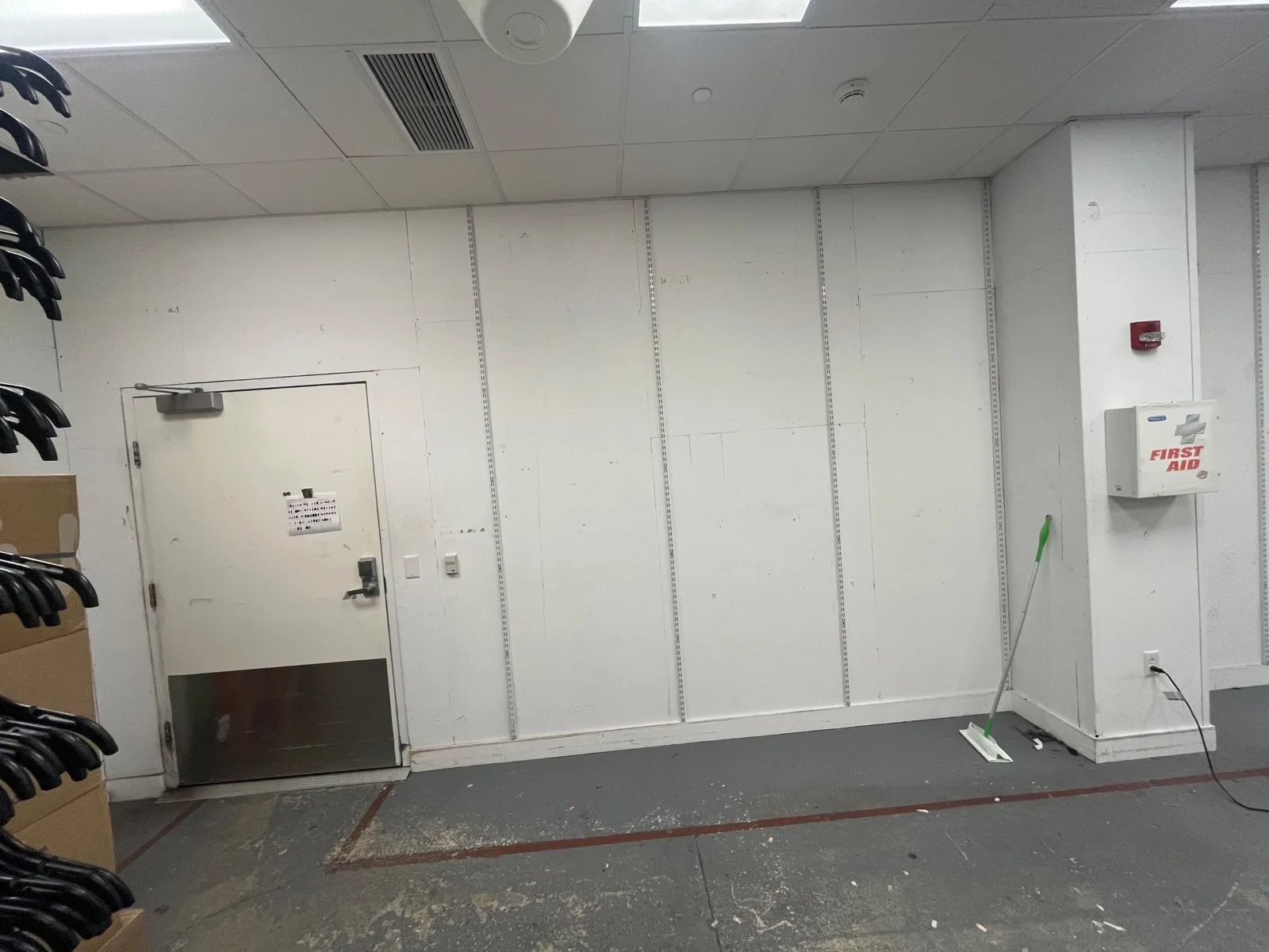 Back-of-house stockroom wall before RFID shielding paint